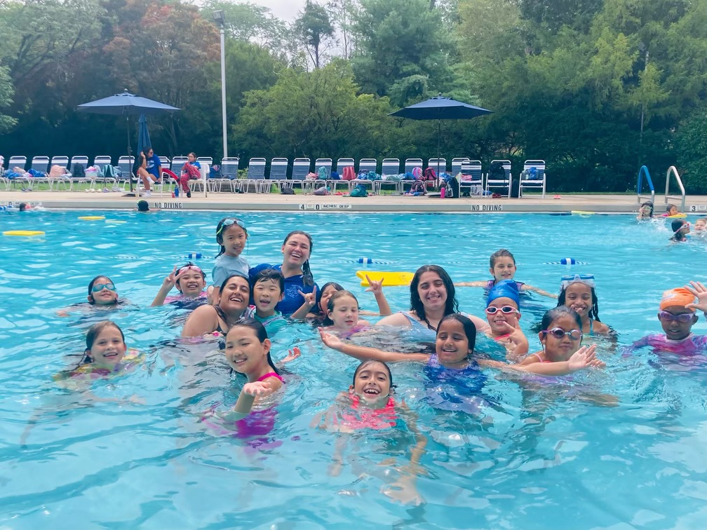 Fresh Meadows Campers posing for a photo in the pool at World of Discovery Day Camp.
